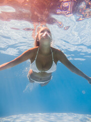 Wall Mural - Woman underwater at the pool