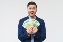 Businessman Holding Fan Of Euro Notes In Hands, Feeling Excited, Amazed And Happy About Becoming Rich, Isolated On Gray Background
