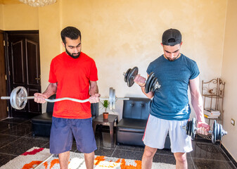 Wall Mural - Two brothers weight lifting and doing sports together at home