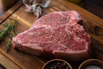 Wall Mural - thick cut t-bone steak seasoned with salt and pepper