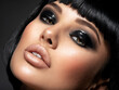 © Valua Vitaly - Сloseup face of a sexy fashion model with black gloss make-up.  Portrait of a beautiful brunette woman looks to the camera.   Attractive white girl with black eye-makeup.  Art. .