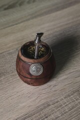 Wall Mural - Argentinian Yerba Mate tea in an eco-friendly wooden container with a metal straw