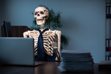 Young male employee working in the office night time