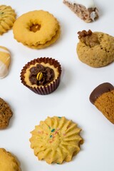 Wall Mural - Vertical shot of different kind of cookies isolated on a white background