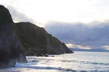 Canvas Print - Beautiful shot of a cliff in the seashore with a cloudy sky background