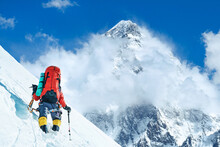 Climber Reaches The Summit Of Mountain Peak. National Park, Nepal.