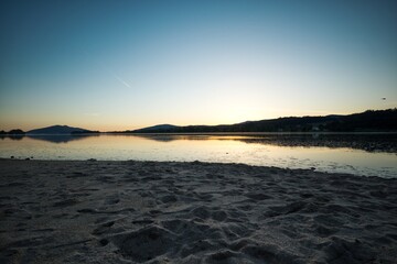 Sticker - Water in front of the sand on the beach during sunset