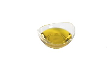 Poster - Closeup shot of a yellow oil in a small glass bowl isolated on white background