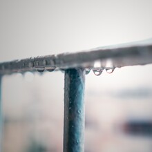 Soft Focus Of Water Droplets Hanging From Railings