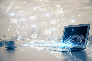 Desktop computer background in office and flying envelops hologram drawing. Multi exposure. Electronic mail concept.