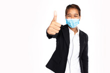 Asian Businesswoman Wearing Surgical Face Mask In Formal Black Suit Jacket, Show Hand Thumps Up, Looking At Camera, Studio Lighting Isolated On White Background, Coronavirus, COVID-19 Concept