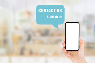 Call Center and Contact US Concept : Hand holding smartphone with blank white screen and contact icons symbols in chatting balloon.