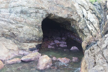 Sea Cave And Rocks On Coastline Of Beach