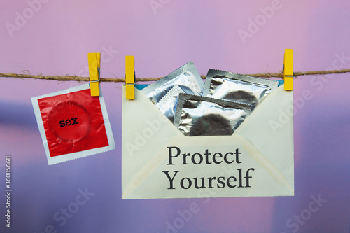 Fotomural seven condoms on a rope like seven days a week