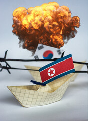 Wall Mural - paper ship with Flags of North Korea and South Korea barbed wire between them. border conflict concept