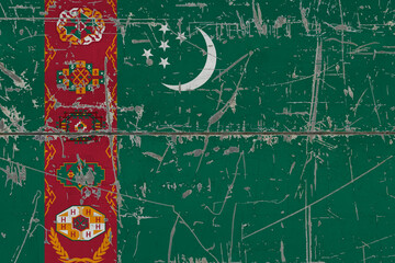 Turkmenistan flag painted on cracked dirty surface. National pattern on vintage style surface. Scratched and weathered concept.