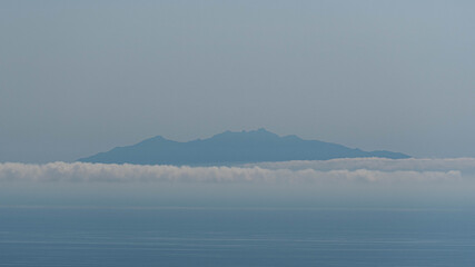 Wall Mural - misty morning on Monte Cristo Island seen from Corsica