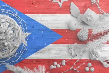 Wall Mural - Puerto Rico flag on wooden table with snow objects. Christmas and new year background, celebration national concept with white decor.