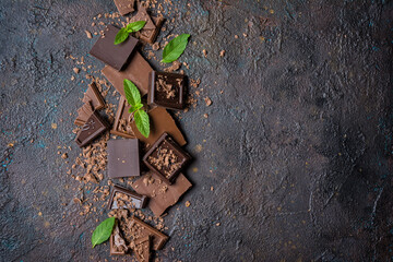 Wall Mural - Pieces of tasty milk and dark chocolate with fresh mint leaves