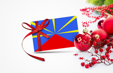 Reunion flag on new year invitation card with red christmas ornaments concept. National happy new year composition.