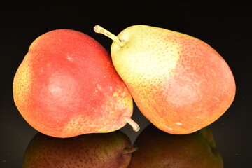 Sweet ripe pears, close-up, on a black background.