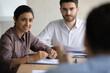 © fizkes - Diverse employees attentively listening to team leader at meeting, staff training concept, business partners discussing strategy in boardroom, two hr managers holding job interview with candidate