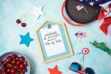 Celebrate at home 4th of July concept with photo frame and patriotic home decor. Top view from above