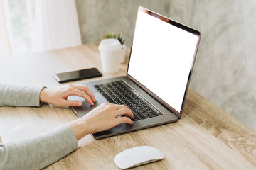 Wall Mural - woman using laptop and working on wooden table