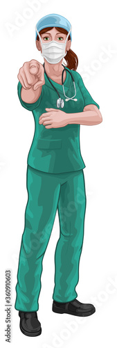 Fotomural A woman nurse or doctor in surgical or hospital scrubs and mask pointing in a your country needs or wants you gesture