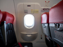 Emergency Exit Window In Aircraft Cabin. Long Leg Room Seat. Premium Seat. Emergency Exit Seat.