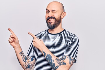 Canvas Print - Young handsome man wearing casual clothes smiling and looking at the camera pointing with two hands and fingers to the side.