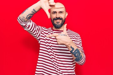 Canvas Print - Young handsome man wearing casual clothes smiling making frame with hands and fingers with happy face. creativity and photography concept.