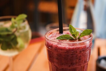 Poster - Closeup shot of berry smoothie on wooden table