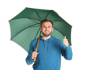 Poster - Handsome young man with umbrella showing thumb-up on white background