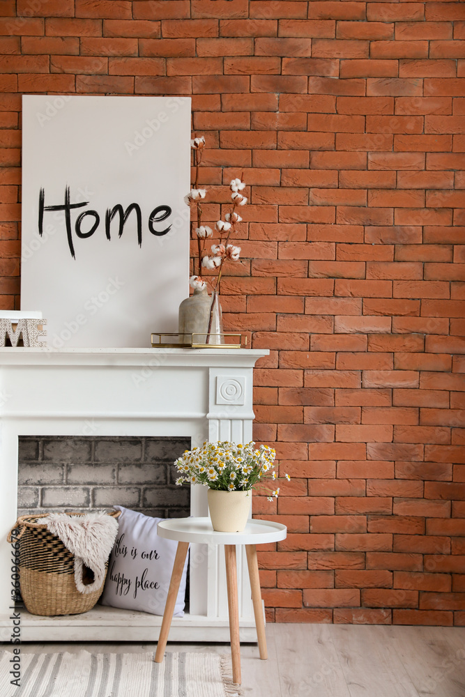 Stylish fireplace with table in interior of living room