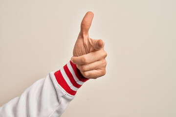 Hand of caucasian young man showing fingers over isolated white background pointing forefinger to the camera, choosing and indicating towards direction