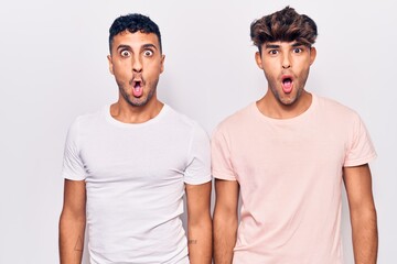 Sticker - Young gay couple wearing casual clothes afraid and shocked with surprise expression, fear and excited face.