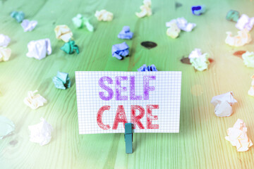 Writing note showing Self Care. Business concept for the practice of taking action to preserve or improve one s is health Colored crumpled rectangle shaped reminder paper light blue background