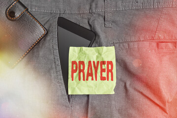 Wall Mural - Handwriting text writing Prayer. Conceptual photo solemn request for help or expression of thanks addressed to God Smartphone device inside trousers front pocket with wallet and note paper