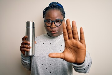 Poster - Young african american plus size woman with braids holding thermo with coffee with open hand doing stop sign with serious and confident expression, defense gesture