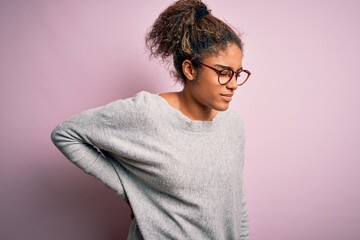 Sticker - Young beautiful african american girl wearing sweater and glasses over pink background Suffering of backache, touching back with hand, muscular pain