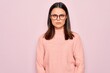 © Krakenimages.com - Young beautiful brunette woman wearing casual sweater and glasses over pink background skeptic and nervous, frowning upset because of problem. Negative person.
