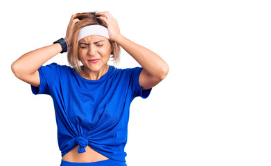 Poster - Young blonde woman wearing sportswear suffering from headache desperate and stressed because pain and migraine. hands on head.