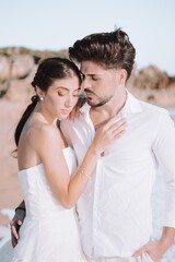 Poster - Loving couple standing closely next to each other on the beach