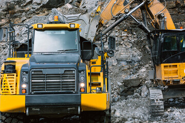 Wall Mural - Excavator loads ore into a mining dump truck.
