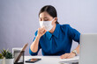 © chajamp - Asian woman in blue shirt wearing protective face mask, was sick with sore throat, at office. isolated on white background.