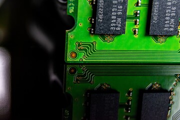 Closeup of a random access memory stick under the lights on a dark blurry background