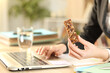 © PheelingsMedia - Entrepreneur hands holding snack bar working on laptop