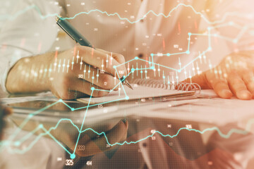 Multi exposure of man planing investment with stock market forex chart.