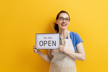 business owner holding the sign for the reopening